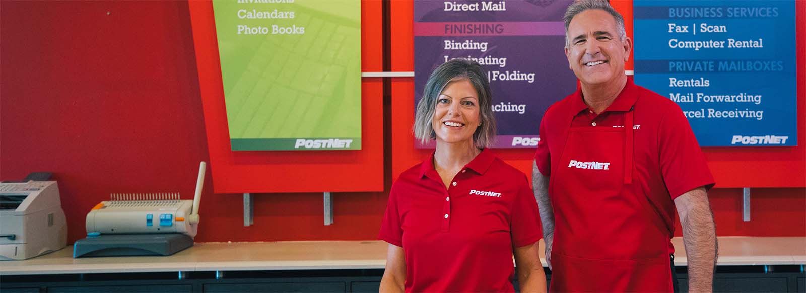 Two Postnet Franchise owners smiling for photo.