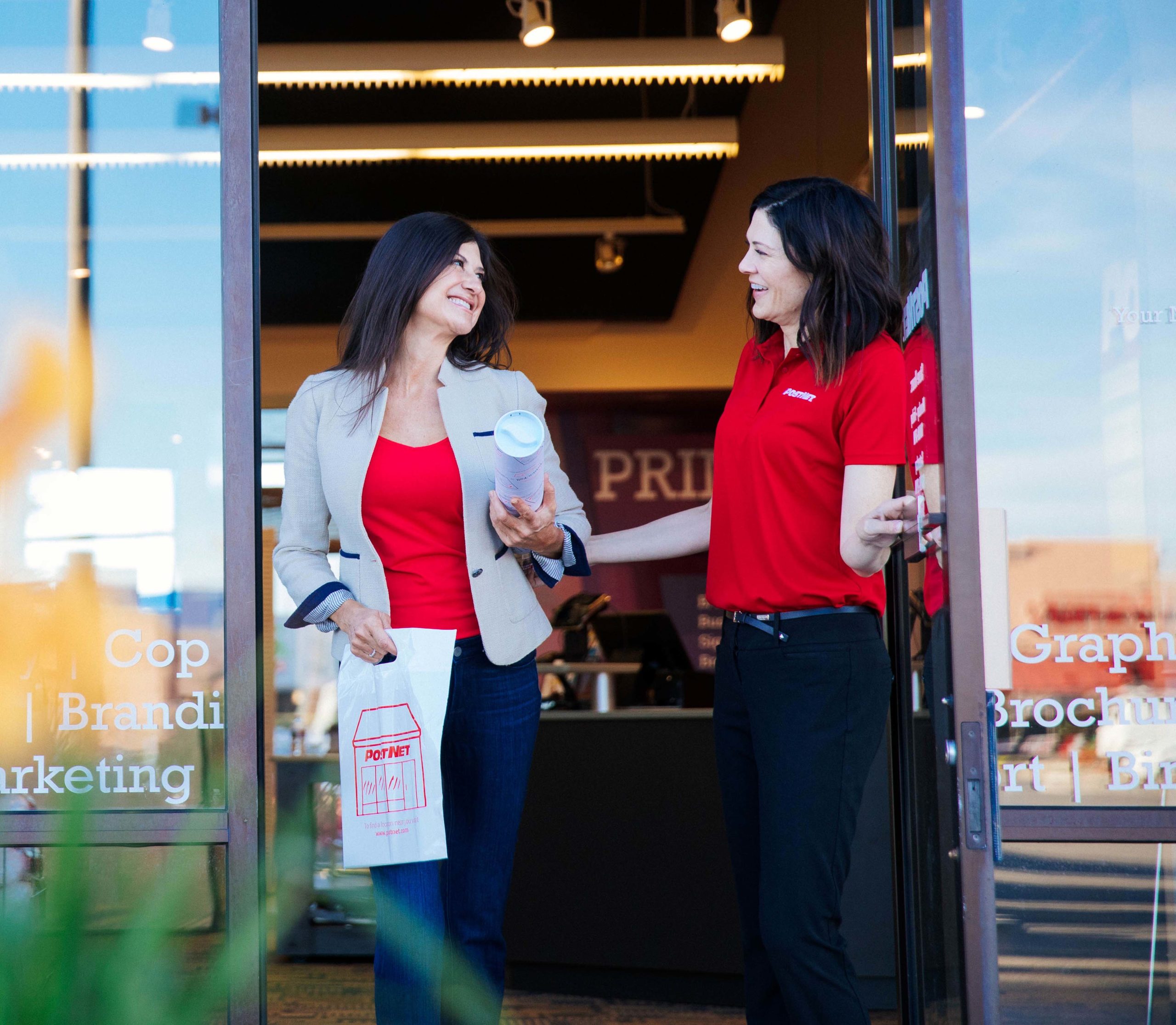 PostNet employee assisting customer with products